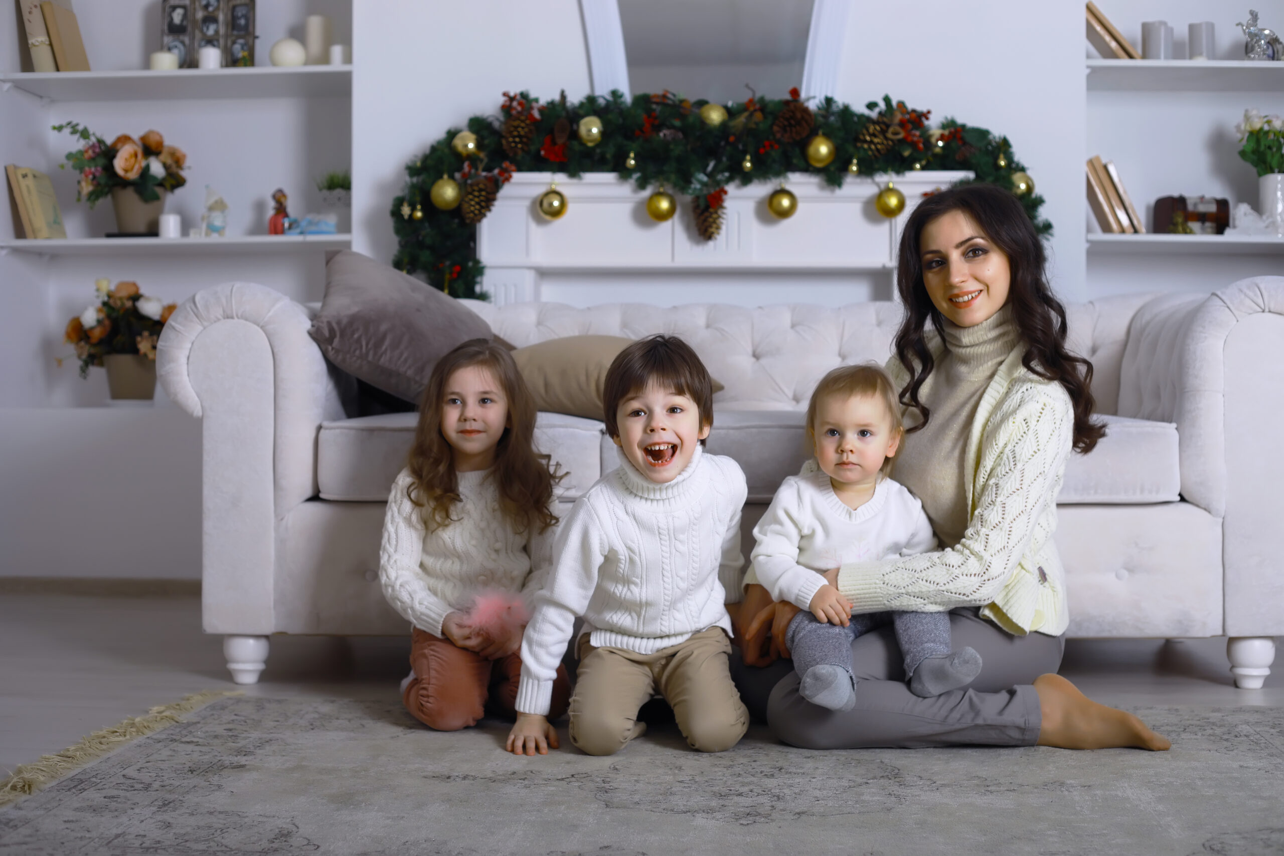 A young family with children decorates the house for the holiday